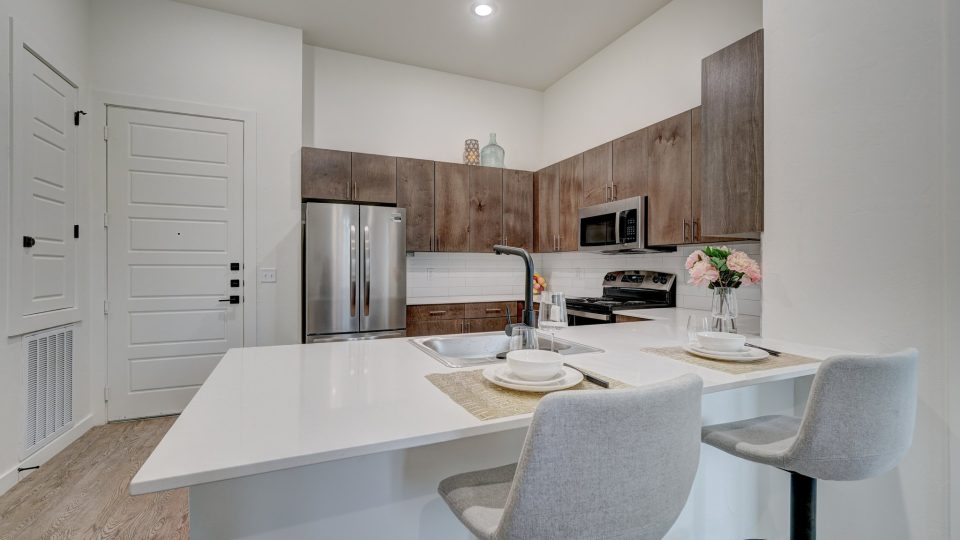 a kitchen with white cabinets and stainless steel appliances at The  Campbell