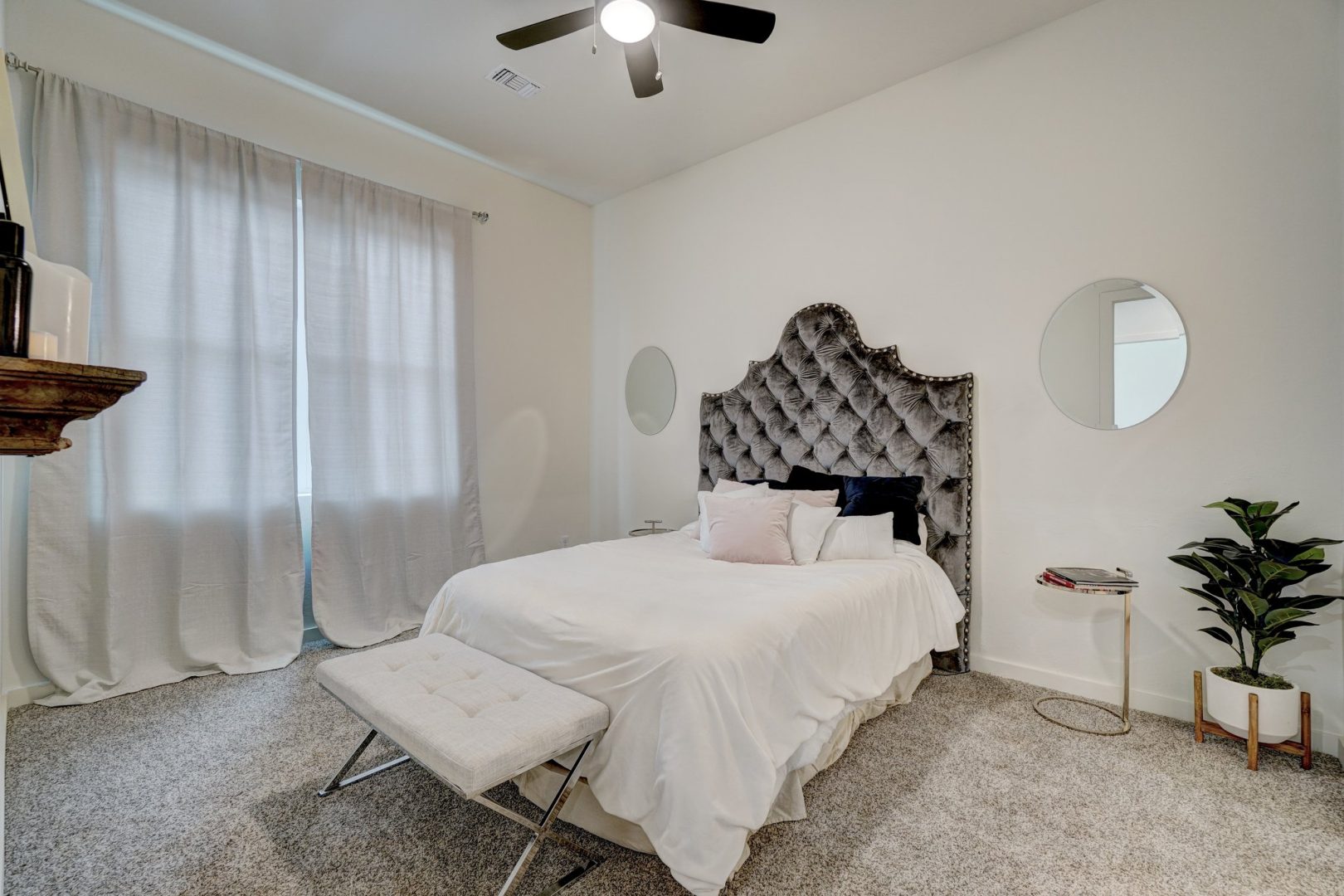 a bedroom with a white bed and a ceiling fan at The  Campbell